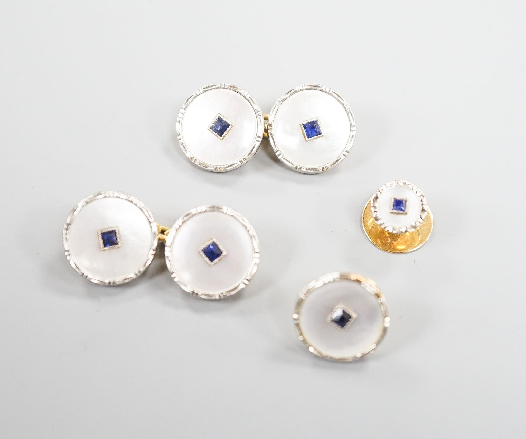 A pair of 18ct, mother of pearl and sapphire set circular cufflinks, 13mm and a pair of matching dress studs, gross weight 8.6 grams.